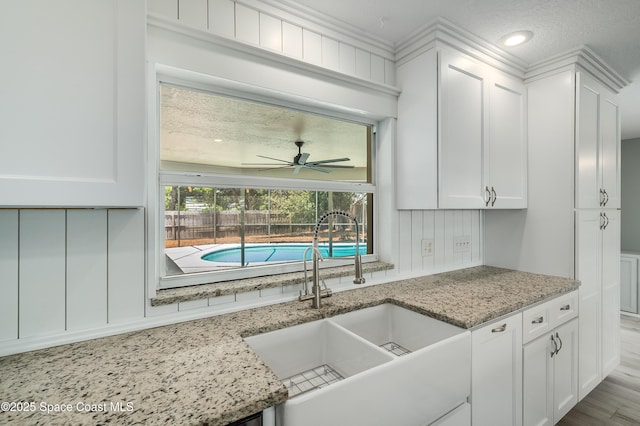 kitchen featuring a sink, white cabinets, a ceiling fan, and recessed lighting