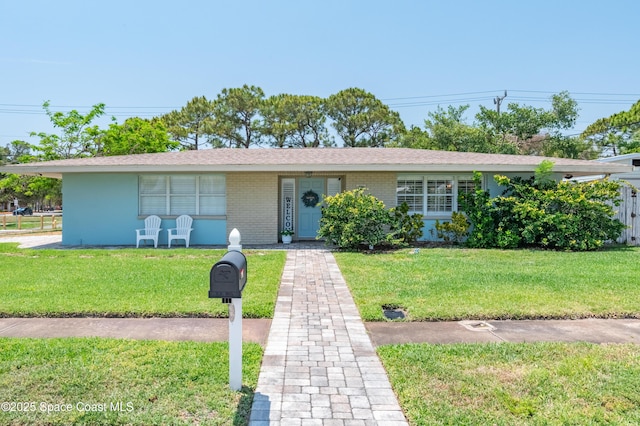 single story home with a front lawn and brick siding