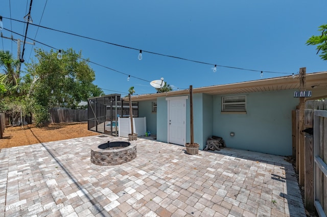 view of patio with a fenced backyard and a fire pit