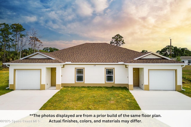 125 Admiral Cir, Sebastian, FL 32958 - view of front facade with a garage, driveway, a lawn, and stucco siding