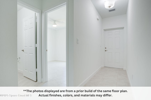 125 Admiral Cir, Sebastian, FL 32958 - hall with light tile patterned floors and baseboards