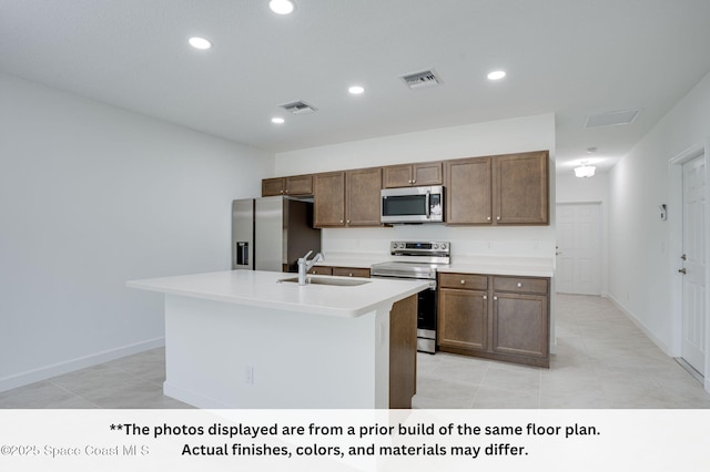 125 Admiral Cir, Sebastian, FL 32958 - kitchen featuring appliances with stainless steel finishes, a sink, light tile patterned flooring, light countertops, and recessed lighting