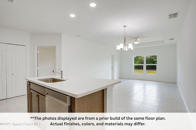 125 Admiral Cir, Sebastian, FL 32958 - kitchen featuring stainless steel dishwasher, a sink, open floor plan, light tile patterned floors, and light countertops