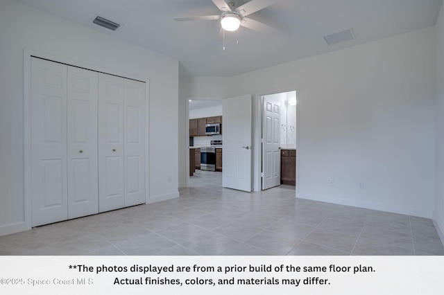 125 Admiral Cir, Sebastian, FL 32958 - unfurnished bedroom featuring a closet, baseboards, and light tile patterned flooring
