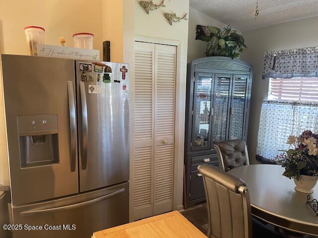 kitchen featuring stainless steel fridge with ice dispenser