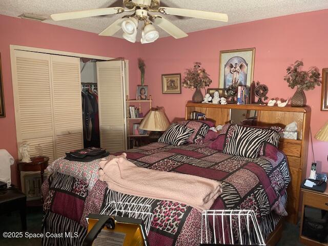 bedroom with a closet, a textured ceiling, and a ceiling fan
