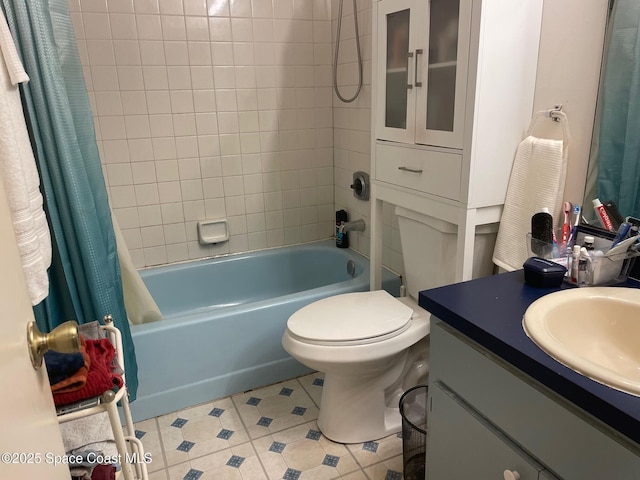 full bathroom with tile patterned flooring, shower / bath combo with shower curtain, vanity, and toilet