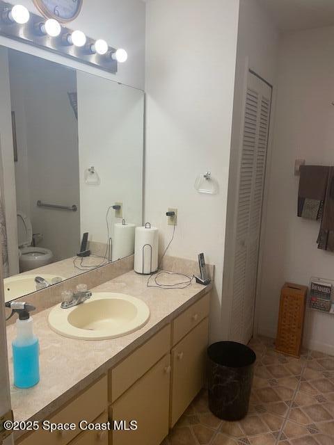 1551 Hardwicke St NW, Palm Bay, FL 32907 - bathroom with a closet, vanity, and tile patterned flooring