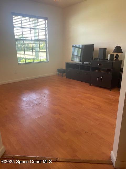 1551 Hardwicke St NW, Palm Bay, FL 32907 - living area featuring light wood finished floors and baseboards