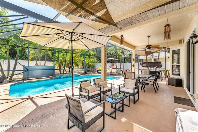 view of pool with a fenced backyard, a patio area, and glass enclosure