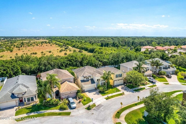 aerial view of residential area featuring a forest