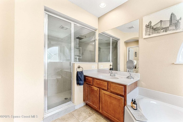 full bathroom with a stall shower, vanity, tile patterned floors, and a garden tub