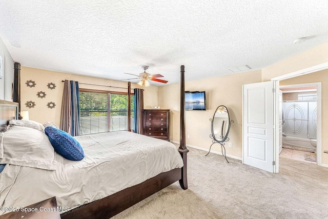 bedroom with light colored carpet, baseboards, a textured ceiling, and a ceiling fan