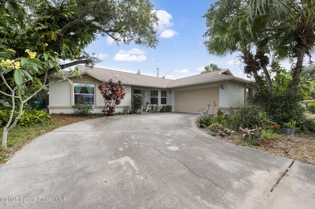225 Chalet Ave, Indialantic, FL 32903 - ranch-style home featuring concrete driveway, a garage, and stucco siding