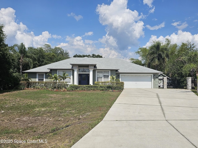 prairie-style home with a garage, a front yard, and driveway
