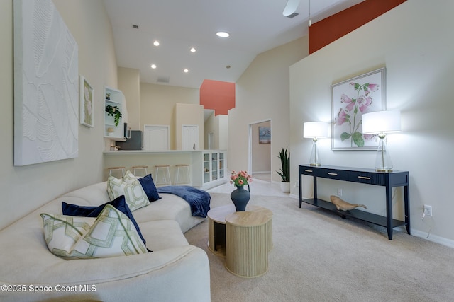 carpeted living area with high vaulted ceiling, baseboards, recessed lighting, and a ceiling fan