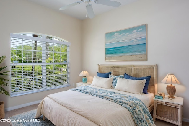 carpeted bedroom with baseboards and a ceiling fan