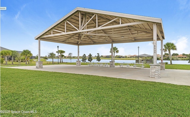 view of community featuring a gazebo, a yard, and a water view
