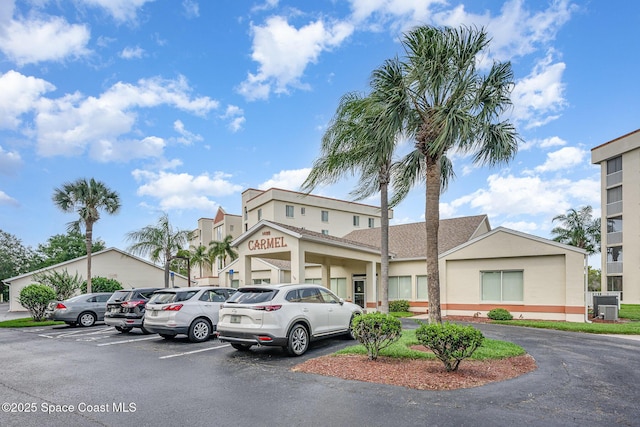 1420 Huntington Ln Unit 2402, Rockledge, FL 32955 - view of property featuring uncovered parking and central air condition unit