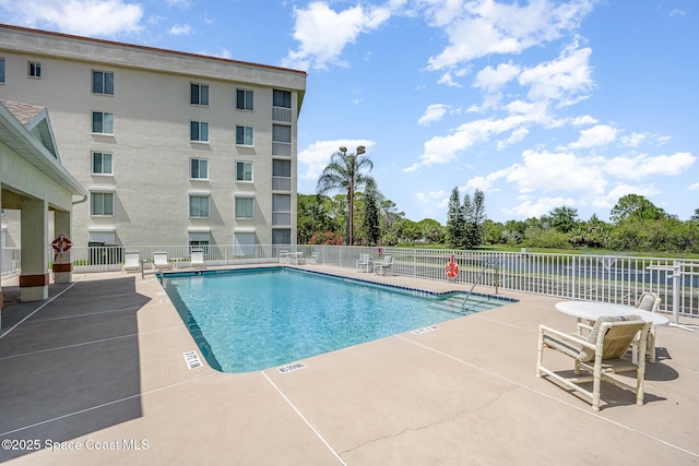 1420 Huntington Ln Unit 2402, Rockledge, FL 32955 - community pool featuring a patio