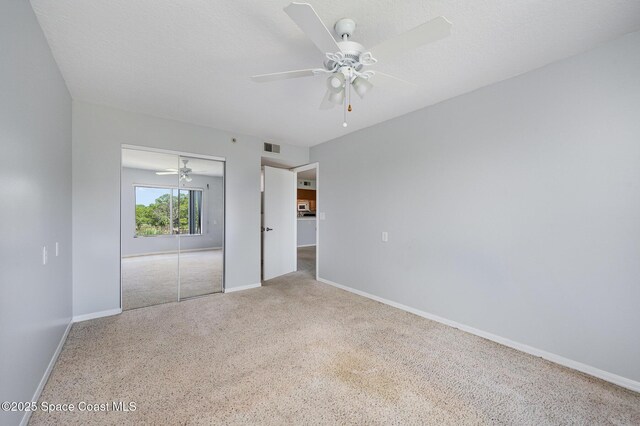 1420 Huntington Ln Unit 2402, Rockledge, FL 32955 - unfurnished bedroom featuring baseboards, carpet flooring, a closet, and ceiling fan