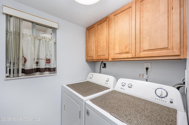 1420 Huntington Ln Unit 2402, Rockledge, FL 32955 - laundry area featuring washing machine and clothes dryer, cabinet space, and a textured ceiling