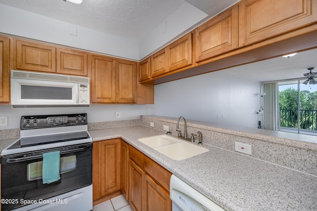 1420 Huntington Ln Unit 2402, Rockledge, FL 32955 - kitchen featuring white appliances, a sink, light countertops, brown cabinets, and light tile patterned floors