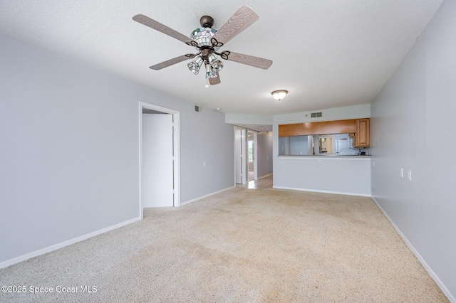 1420 Huntington Ln Unit 2402, Rockledge, FL 32955 - unfurnished living room with light colored carpet, a ceiling fan, and baseboards