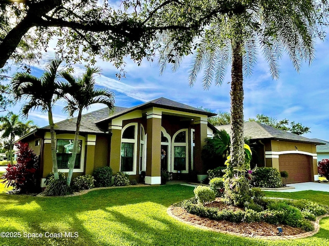 679 Sheridan Woods Dr, Melbourne, FL 32904 - view of front of property featuring stucco siding, a garage, and a front lawn