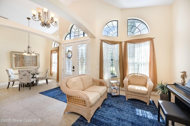 679 Sheridan Woods Dr, Melbourne, FL 32904 - living room featuring a chandelier, plenty of natural light, arched walkways, and a towering ceiling