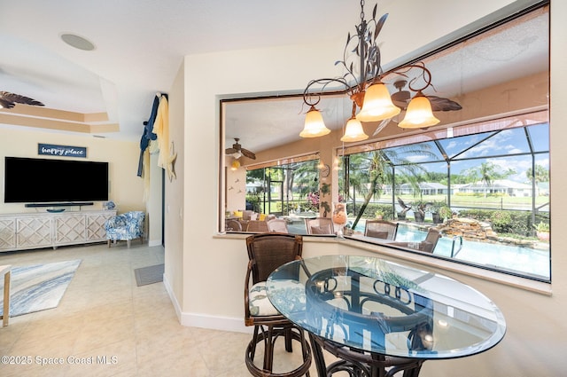 679 Sheridan Woods Dr, Melbourne, FL 32904 - dining space with baseboards, a ceiling fan, and a sunroom