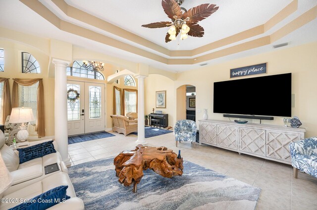 679 Sheridan Woods Dr, Melbourne, FL 32904 - tiled living area with decorative columns, arched walkways, a tray ceiling, french doors, and a ceiling fan