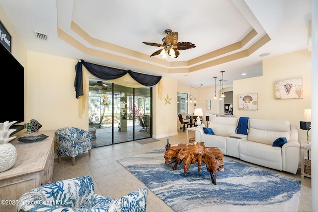 679 Sheridan Woods Dr, Melbourne, FL 32904 - living room with a tray ceiling, a ceiling fan, and light tile patterned floors