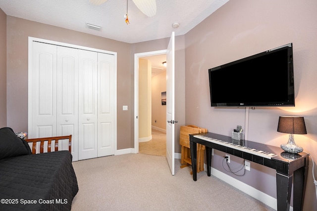 679 Sheridan Woods Dr, Melbourne, FL 32904 - bedroom with a closet, light colored carpet, baseboards, and ceiling fan