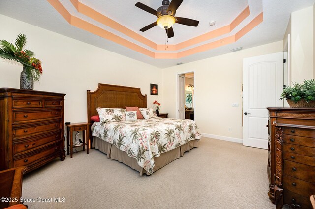 679 Sheridan Woods Dr, Melbourne, FL 32904 - bedroom featuring carpet, a raised ceiling, baseboards, and a ceiling fan