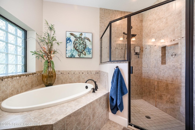 679 Sheridan Woods Dr, Melbourne, FL 32904 - bathroom with a bath, a stall shower, and tile patterned floors