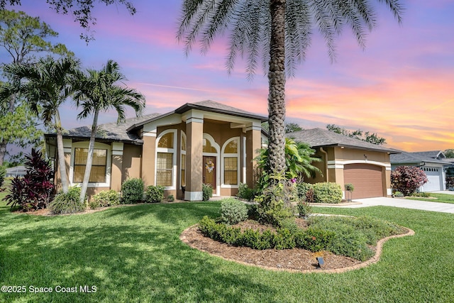 679 Sheridan Woods Dr, Melbourne, FL 32904 - view of front of house with stucco siding, an attached garage, driveway, and a lawn