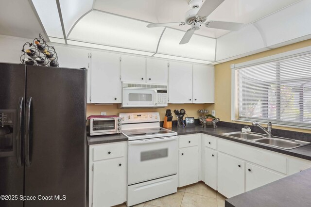 670 26th Ct, Vero Beach, FL 32962 - kitchen featuring white appliances, a sink, dark countertops, white cabinetry, and ceiling fan