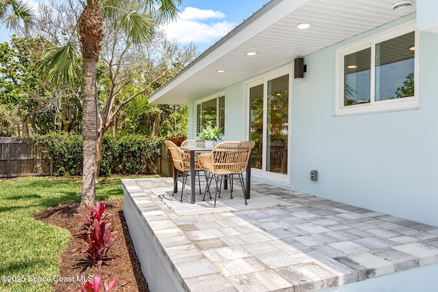 view of patio featuring fence and outdoor dining space