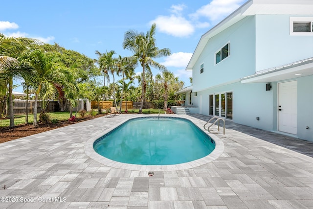 view of swimming pool featuring a patio and a fenced backyard