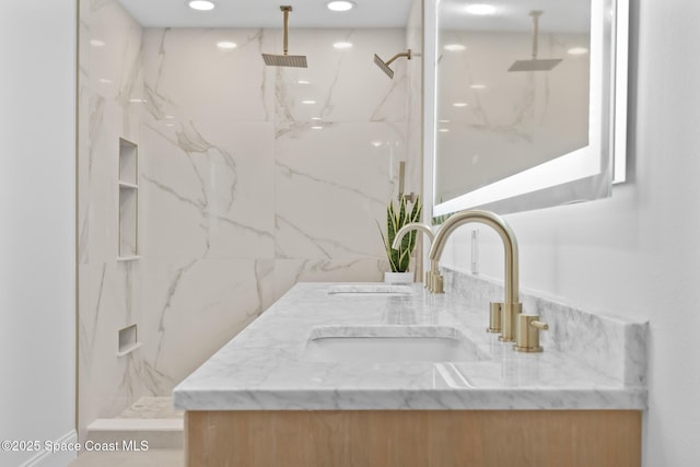 bathroom featuring a marble finish shower, vanity, and recessed lighting