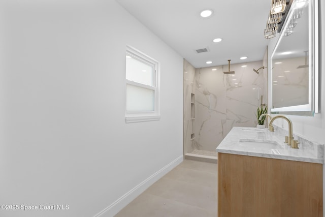 full bathroom with a marble finish shower, recessed lighting, double vanity, and baseboards