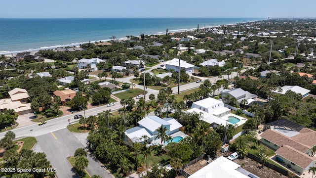 aerial view of residential area featuring expansive beach