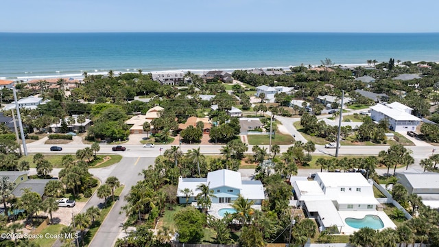 aerial perspective of suburban area featuring extended coastline and a pool area