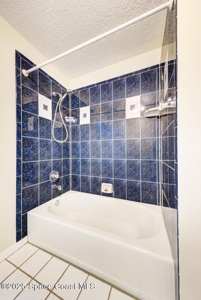 bathroom featuring a textured ceiling and shower / tub combination