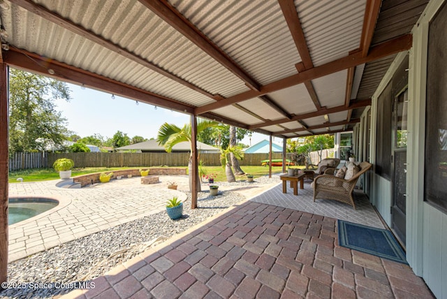 view of patio with a fenced backyard and an outdoor living space with a fire pit