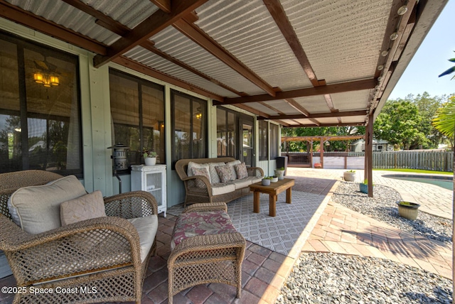 view of patio featuring fence and an outdoor living space