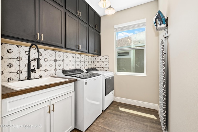3631 Stabane Pl, Melbourne, FL 32940 - laundry area with cabinet space, washer and clothes dryer, baseboards, and dark wood-type flooring