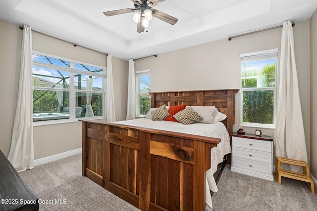 3631 Stabane Pl, Melbourne, FL 32940 - bedroom with light colored carpet, a tray ceiling, baseboards, and a ceiling fan