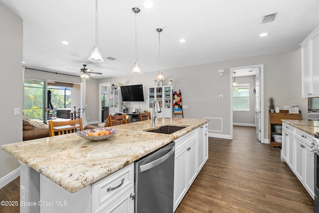 3631 Stabane Pl, Melbourne, FL 32940 - kitchen featuring dishwasher, a sink, baseboards, dark wood finished floors, and white cabinets